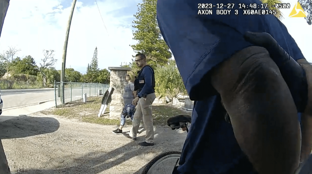 Sarasota Police Bodycam: Suspects Caught Smoking Crack Near Middle School Two people walking near a parking lot.
